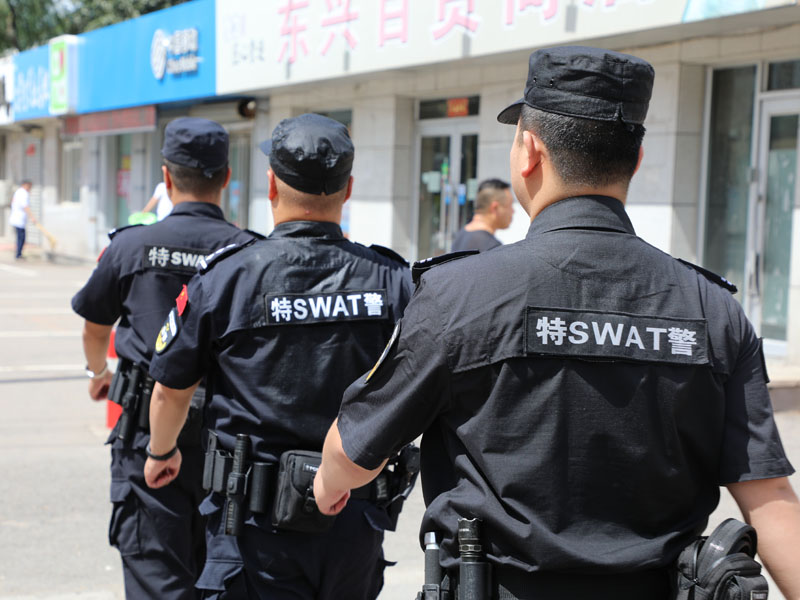 烈日下，巡特警隊(duì)員身上的汗水浸濕了警服