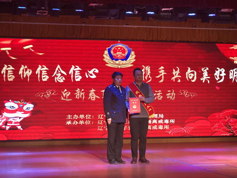 省司法廳副廳長椰永濤（左）為宋曉頒發(fā)聘書,，佩戴戒毒公益大使綬帶